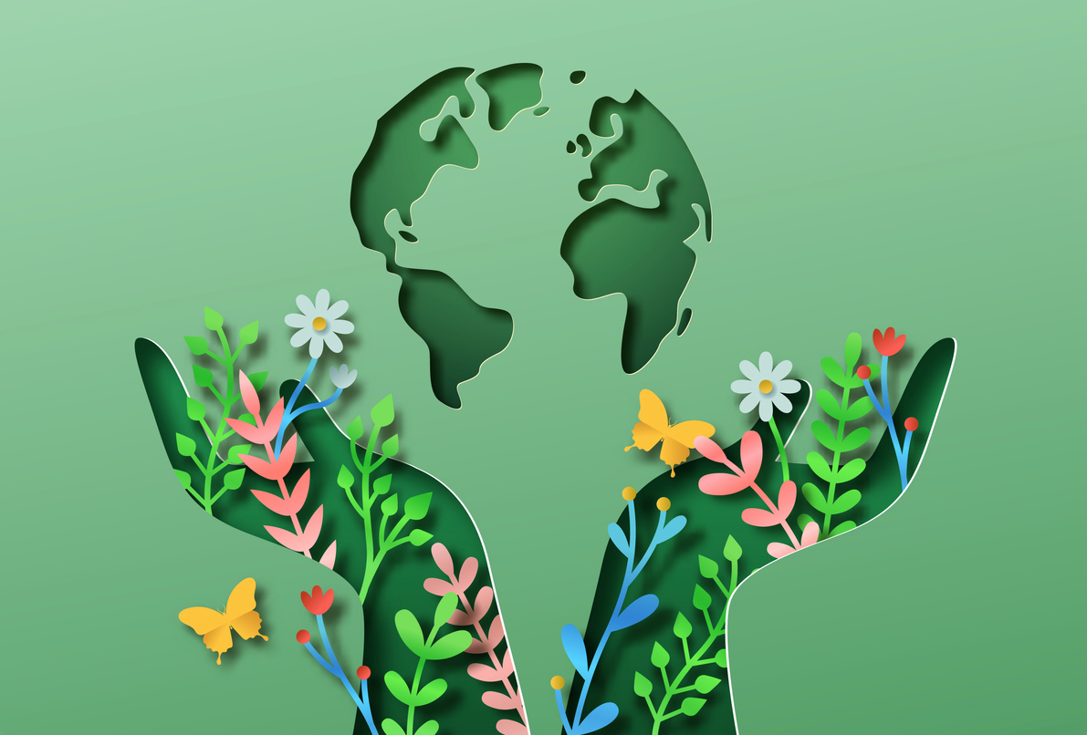 hands formed from flowers and plants support a graphic of the world